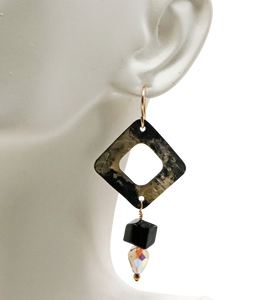 Golden steel earrings on bust