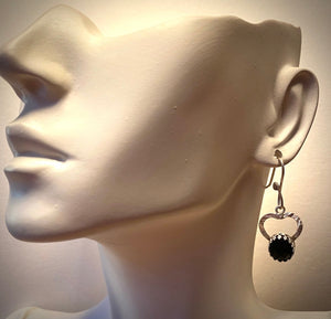 black onyx earrings on earlobe