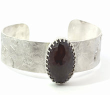 Load image into Gallery viewer, Silver cuff bracelet with a dark stone on a white background