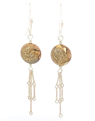 Pair of earrings with stone beads and chain extensions on a white background