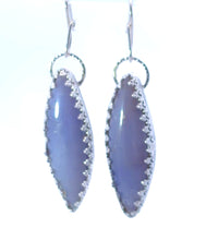 Load image into Gallery viewer, Pair of silver earrings with purple stone on a white background