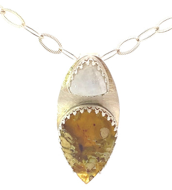 Gold necklace with a pendant featuring a yellow stone on a white background