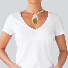 Load image into Gallery viewer, Person wearing a white t-shirt with a necklace featuring a large pendant.