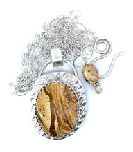Load image into Gallery viewer, Silver pendant with a textured brown center on a white background