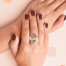 Load image into Gallery viewer, Hand wearing a size 9 sterling silver ring with a faceted rose quartz gem, showcasing its unique design and pink hue.