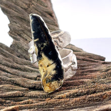 Load image into Gallery viewer, Silver ring with a large, palmwood stone on a wooden surface