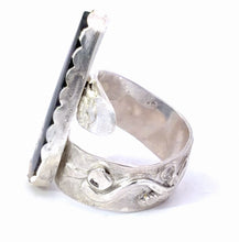 Load image into Gallery viewer, Silver ring with textured design shown from the side