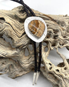 Bolo tie with stone pendant on a piece of driftwood