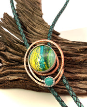 Load image into Gallery viewer, Bolo Tie with Dichroice glass on copper on a wooden surface
