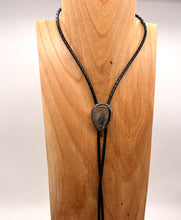 Load image into Gallery viewer, Bolo tie necklace on a wooden mannequin with a plain background