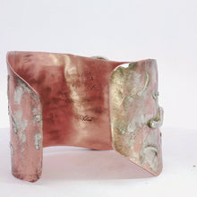 Load image into Gallery viewer, A hammered metal cuff bracelet in copper and silver shown from back