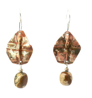 Pair of earrings with brown and gold stone drops on a white background