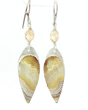 Load image into Gallery viewer, A pair of silver dangle earrings featuring teardrop-shaped natural agate stone  with beige and brown banding, accented by small faceted citrine beads on silver hooks, shown against a plain white background.