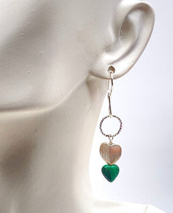 heart earrings shown on ear lobe