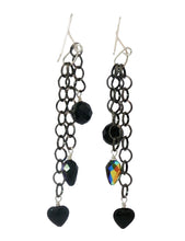 Load image into Gallery viewer, A pair of long dangle earrings with black  rhodium plated links and, black faceted  onyx beads, The earrings are suspended from silver fishhook wires against a plain white background.