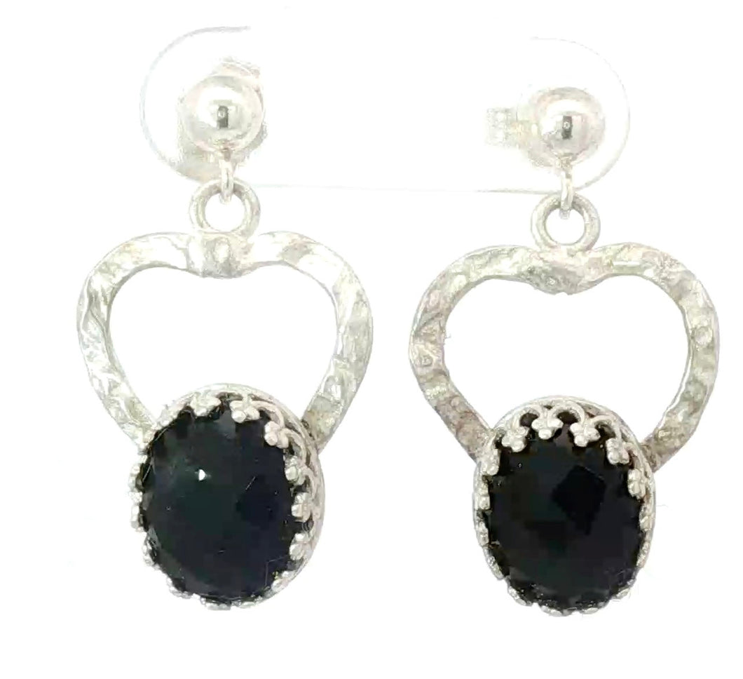 Silver heart-shaped earrings with black gemstones on a white background