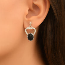 Load image into Gallery viewer, Earring with black gemstone and silver setting worn on an ear