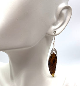 amber earring on lobe