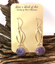 Load image into Gallery viewer, Silver earrings with purple charoite  stones on a wooden surface and branded card.