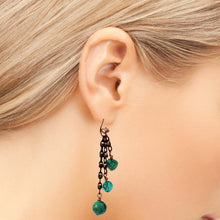 Load image into Gallery viewer, A close-up of a model's ear wearing a long dangle earring with dark metal chains and turquoise gems