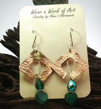 Load image into Gallery viewer, A pair of handmade dangle earrings displayed on a cream-colored jewelry card. The earrings feature textured rose gold  fill diamond-shaped metal with open center loops, hanging from silver-toned fishhook wires.