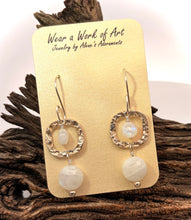 Load image into Gallery viewer, A pair of sterling silver dangle earrings displayed on a gold card that reads 'Wear a Work of Art Jewelry by Alice's Adventures,' set against a piece of rustic driftwood.
