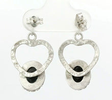 Load image into Gallery viewer, Silver heart-shaped earrings with black stones on a white background