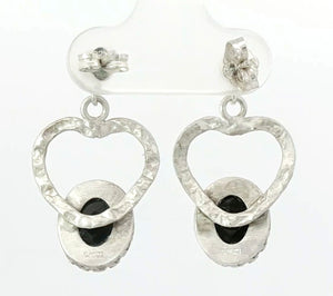 Silver heart-shaped earrings with black stones on a white background