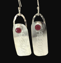 Load image into Gallery viewer, Silver earrings with 'freedom' engraved and ruby gemstone on a black background