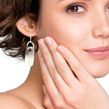 Load image into Gallery viewer, Close-up of a woman wearing an earring with a ruby gemstone and FREEDOM