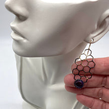 Load image into Gallery viewer, golden steel earring shown on earlobe