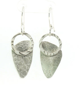 Silver earrings with textured design on a white background