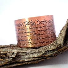 Load image into Gallery viewer, Copper bracelet with engraved text on a wooden branch