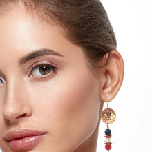 Load image into Gallery viewer, Close-up of a woman wearing a gold earring with colorful beads on a white background