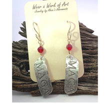Load image into Gallery viewer, Silver MAGA earrings with red crystals on a card against a wooden background