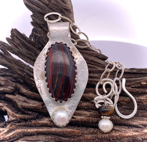 tiger iron pendant in natural setting