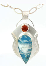 Load image into Gallery viewer, A silver pendant necklace featuring a teardrop-shaped blue  and white clouds, accented by a small round Baltic amber gemstone near the top, 