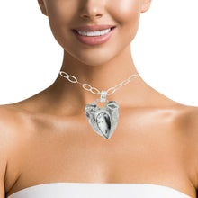 Load image into Gallery viewer, Silver heart-shaped necklace worn by a model on a white background