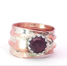 Load image into Gallery viewer, A rustic copper and silver ring with a central faceted garnet red gemstone, photographed on a plain white background.