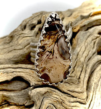Load image into Gallery viewer, petrified palm shown on ring in natural setting
