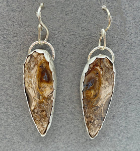 earrings against a grey background for contrast