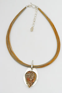 amber pendant shown with neck piece