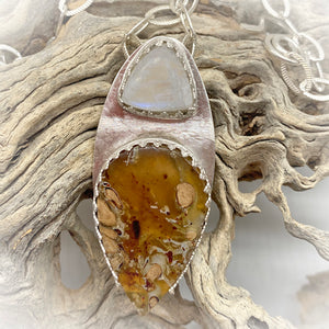 amber and moonstone pendant in natural setting