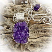 Load image into Gallery viewer, amethyst geode pendant shown in natural setting