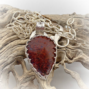 moss agate pendant shown in natural setting