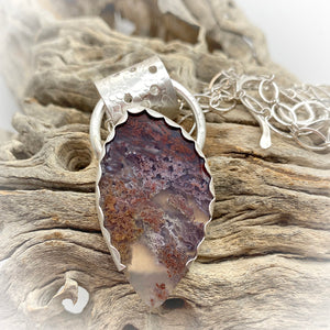 moss agate pendant shown in natural setting