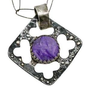 closeup of charoite pendant