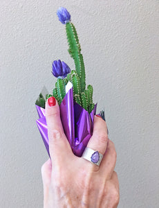 purple charoite gemstone ring shown on hand