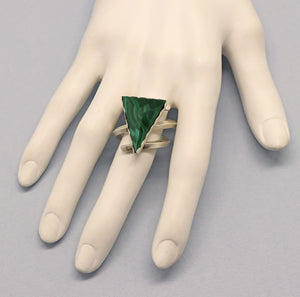 triangle shaped beveled gemstone ring shown on a hand
